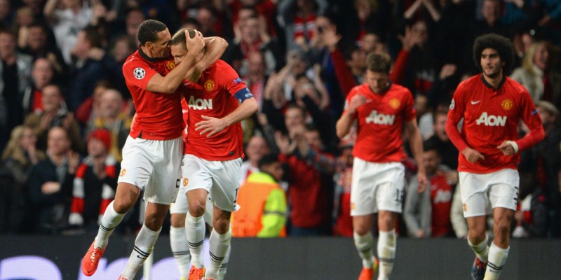 MANCHESTER, ENGLAND - APRIL 01: Rio Ferdinand of Manchester United congratulates Nemanja Vidic of Manchester United on scoring the opening goal during the UEFA Champions League Quarter Final first leg match between Manchester United and FC Bayern Muenchen at Old Trafford on April 1, 2014 in Manchester, England.  (Photo by Michael Regan/Bongarts/Getty Images)