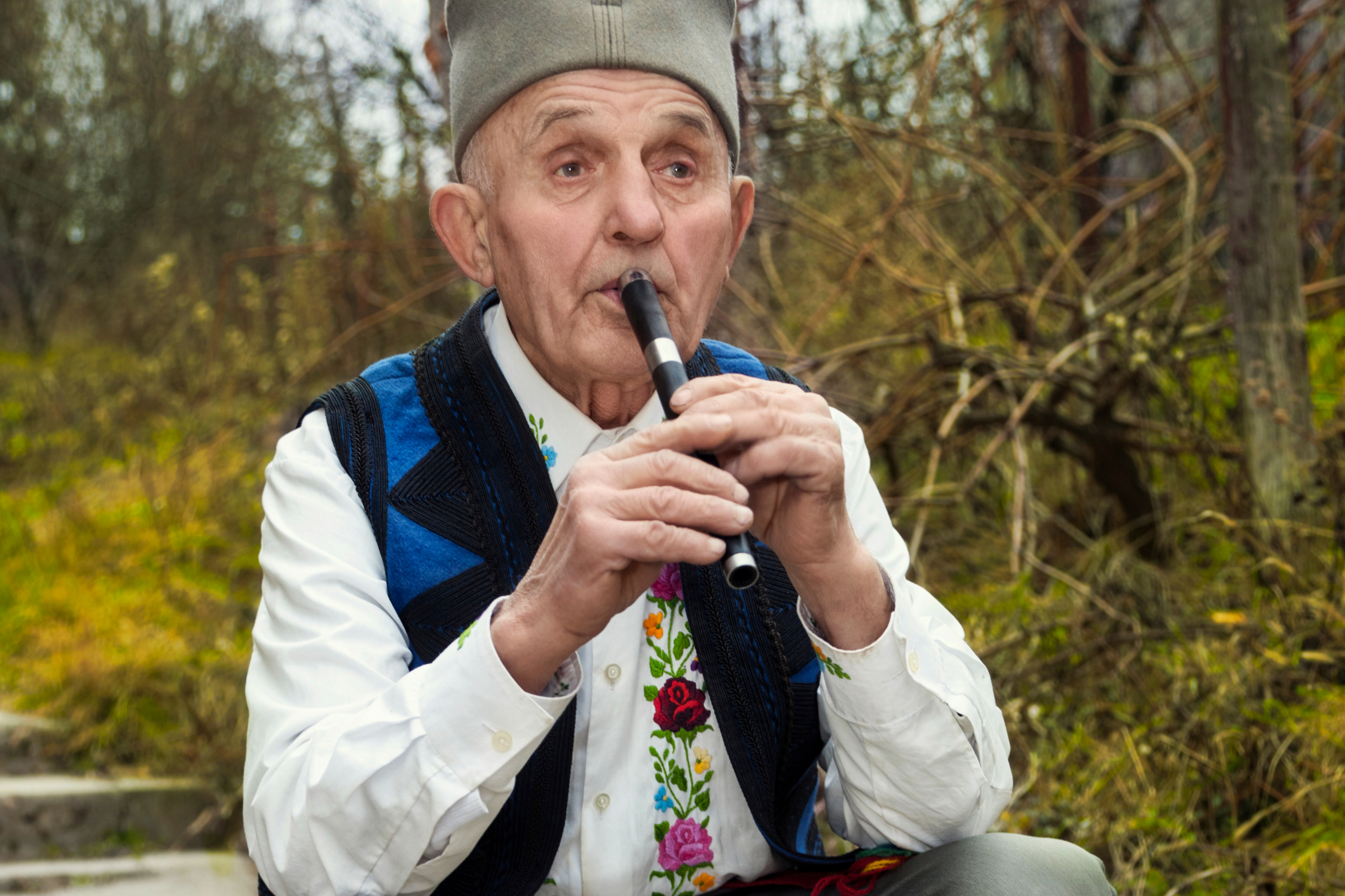 Old man playing fife